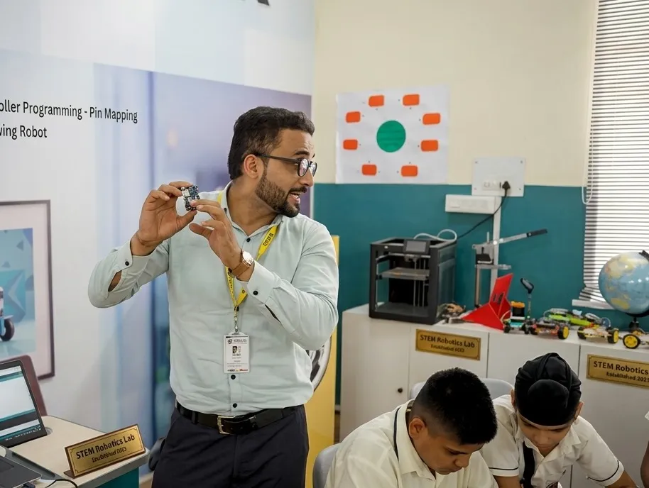 Teacher engaging with students during STEM activity - teacher student relationship